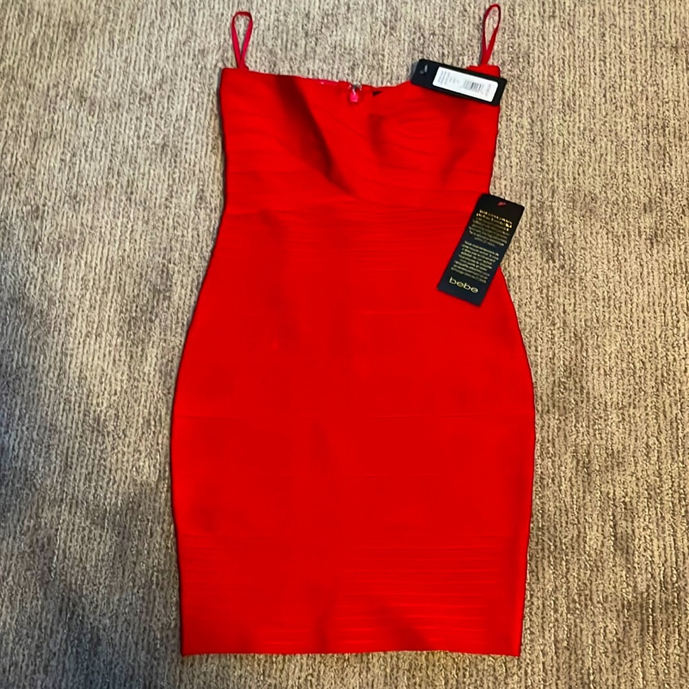 Beautiful red dress by Bebe never been worn and with tags